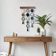 a wooden table topped with a potted plant next to a white wall
