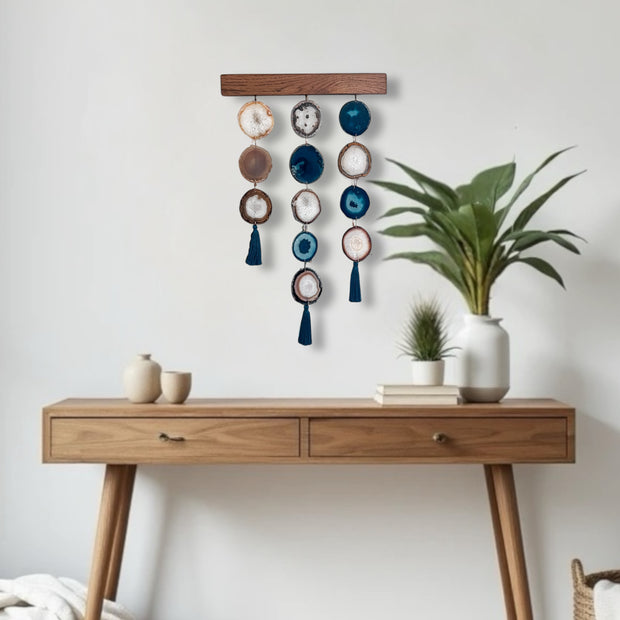 a wooden table topped with a potted plant next to a white wall