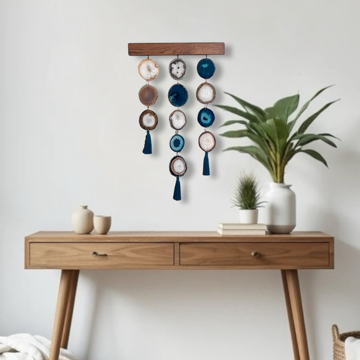a wooden table topped with a potted plant next to a white wall