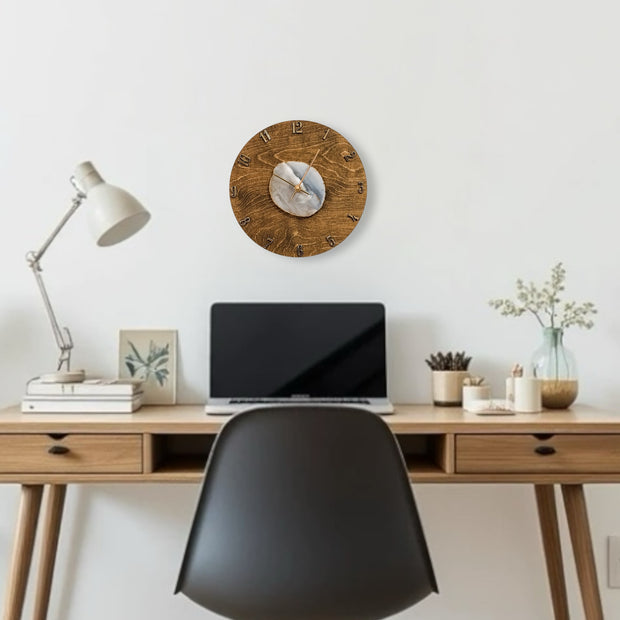 a desk with a laptop and a clock on it