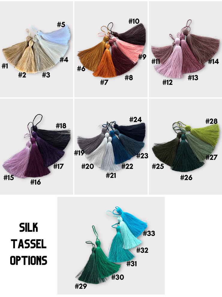 a bunch of different colors of tassels on a white background