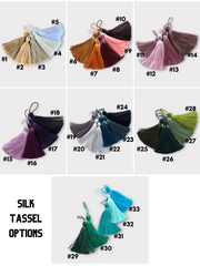 a bunch of different colors of tassels on a white background