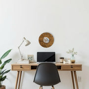 a desk with a laptop and a clock on it