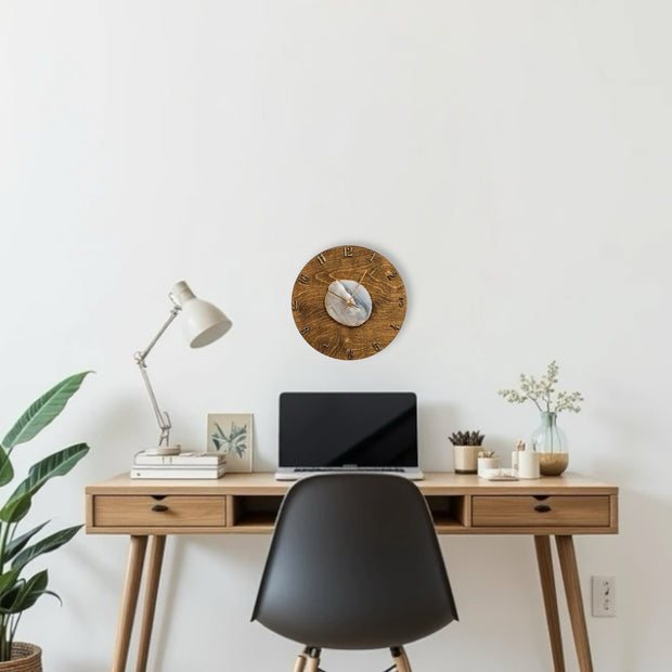 a desk with a laptop and a clock on it