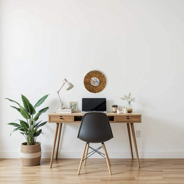 a desk with a laptop and a potted plant