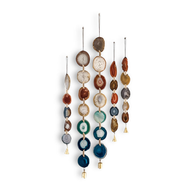 Set of hanging agate slice wall hangings with vintage brass bells on a white background