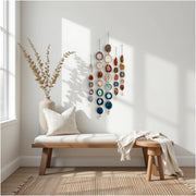 Nestled corner with a wooden bench, decorative wall art, and a vase with plants.