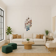 Modern living room with a white sofa, green ottomans, wooden coffee table, and decorative wall art.