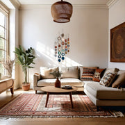 Cozy living room with a beige sectional sofa, coffee table, and decorative elements such as agate wall hanging grouping.