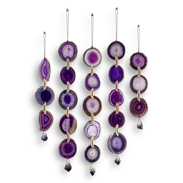Set of purple agate hanging decorations on a white background