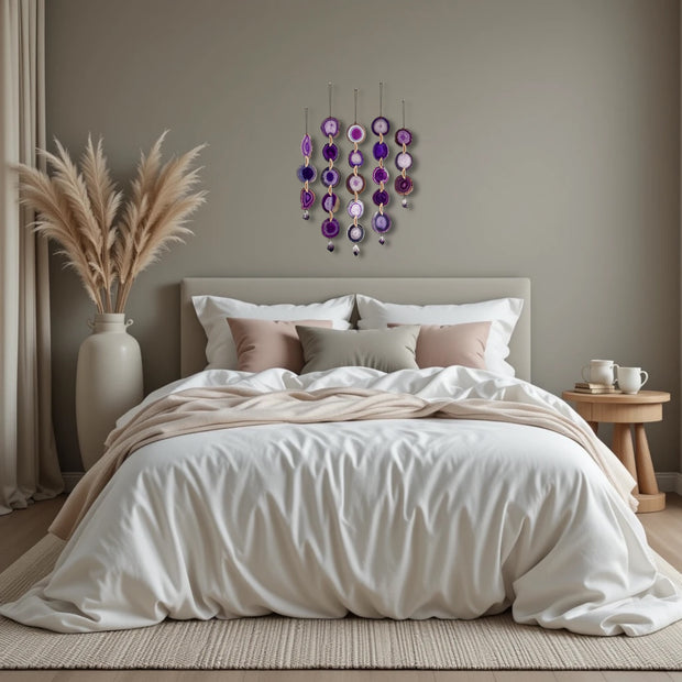 Neatly made bed with decorative pillows in a bedroom setting with wall art and decor.