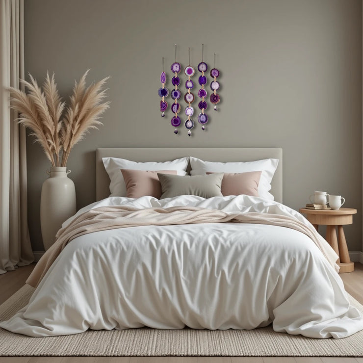 Neatly made bed with decorative pillows in a bedroom setting with wall art and decor.