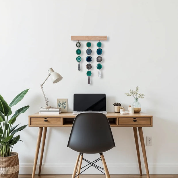 a desk with a laptop and a potted plant