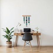 a desk with a laptop and a potted plant