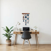 a desk with a laptop and a potted plant